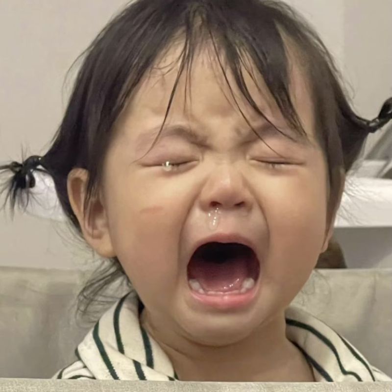 em bé đáng yêu vừa nhăn mặt vừa khóc