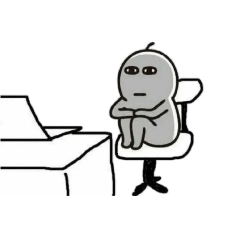 Meme chán nản ngồi co ro, khoanh tay, biểu cảm mệt mỏi trước bàn làm việc